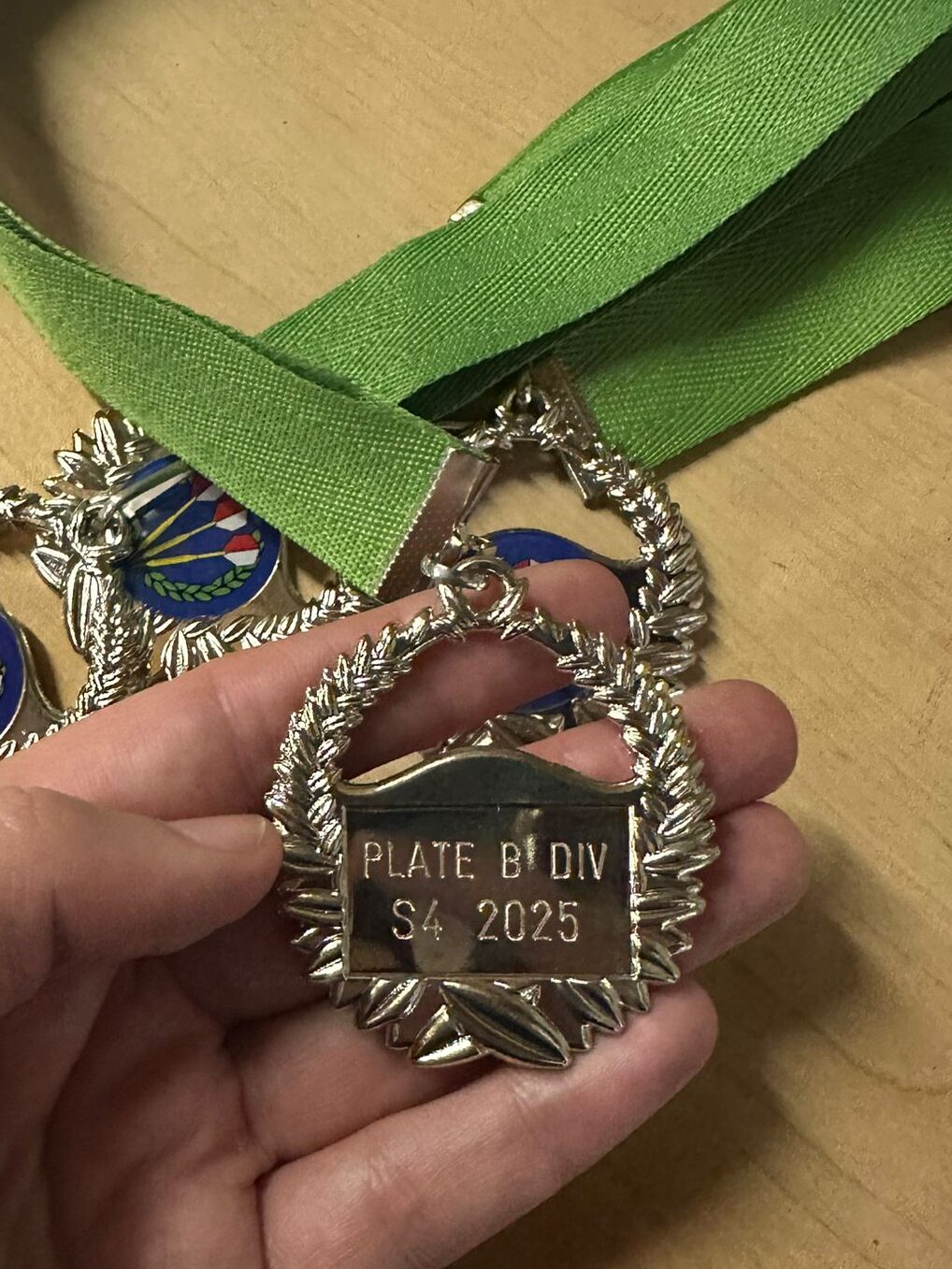 Metal plaque with scratch-engraved text highlighting award recipient details